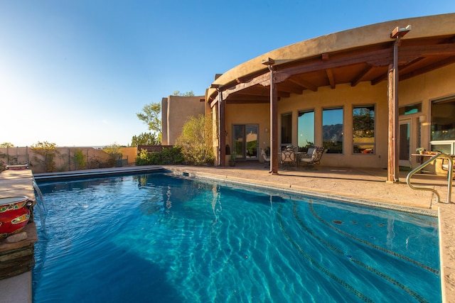 view of swimming pool featuring a fenced in pool, a patio, and fence