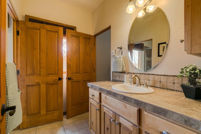 bathroom featuring tile patterned floors, decorative backsplash, and vanity