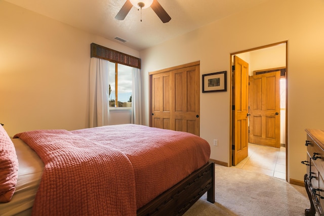 bedroom featuring visible vents, light carpet, a ceiling fan, a closet, and baseboards