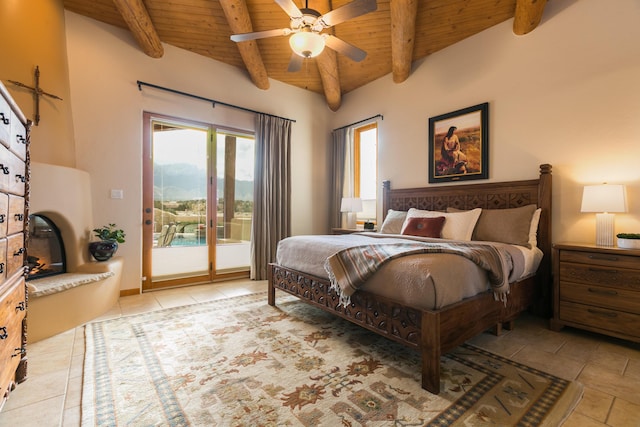 bedroom featuring a glass covered fireplace, access to exterior, wooden ceiling, and beam ceiling