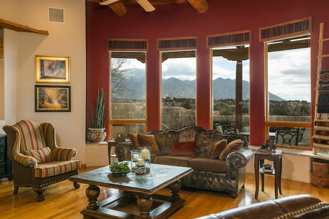 sunroom featuring a mountain view and visible vents