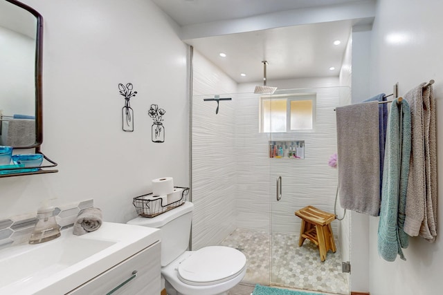 bathroom with vanity, toilet, recessed lighting, and a stall shower