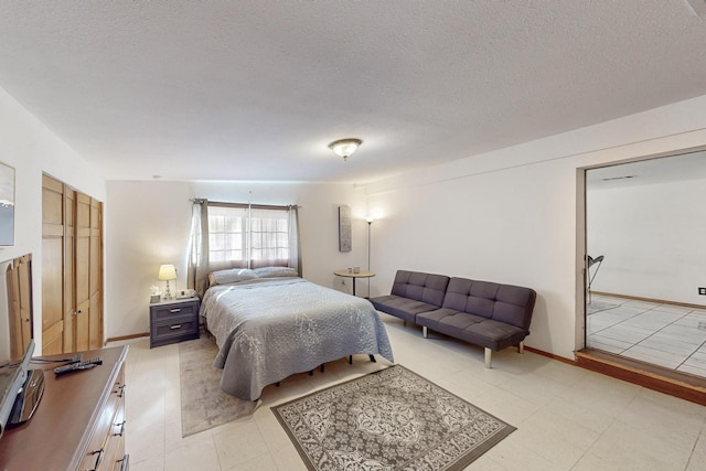 bedroom with baseboards and a textured ceiling