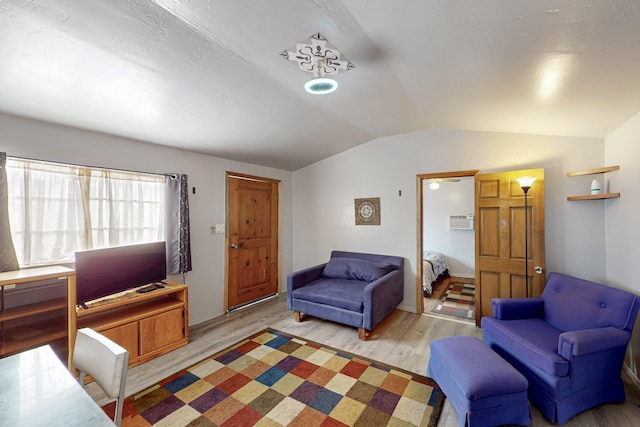 living area with light wood finished floors and lofted ceiling