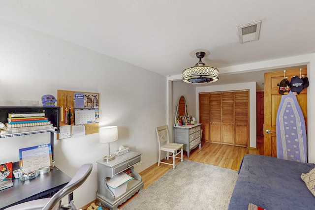 interior space featuring wood finished floors and visible vents