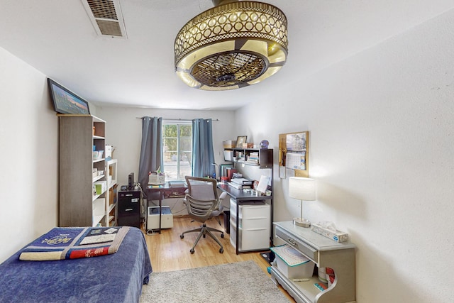 bedroom with visible vents and wood finished floors