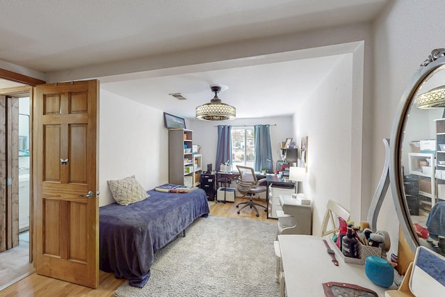 bedroom with visible vents and light wood-style floors