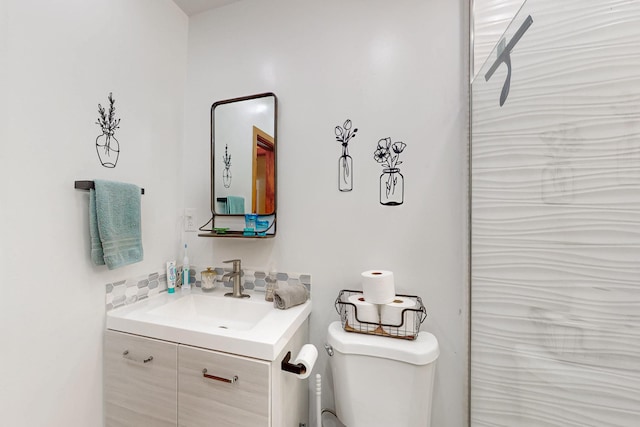 bathroom featuring toilet and vanity