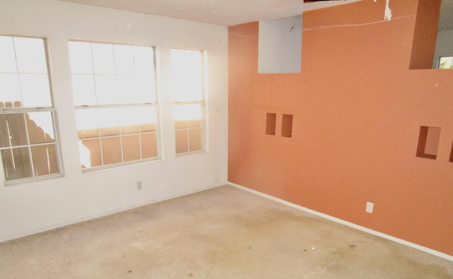 empty room with concrete floors and baseboards