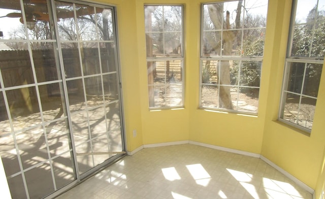 doorway to outside with tile patterned floors and baseboards