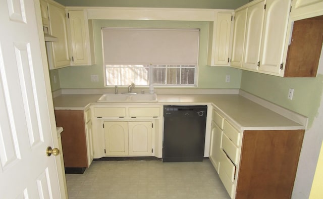 kitchen with light floors, dishwasher, light countertops, and a sink