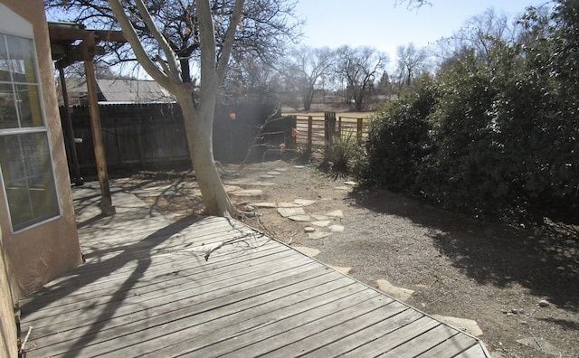 wooden terrace featuring a fenced backyard