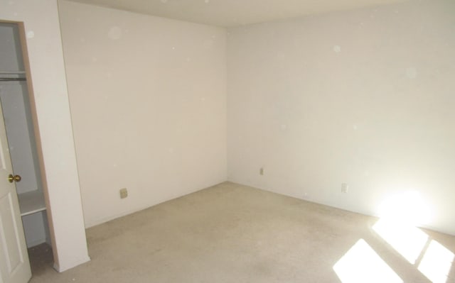 unfurnished bedroom with light colored carpet