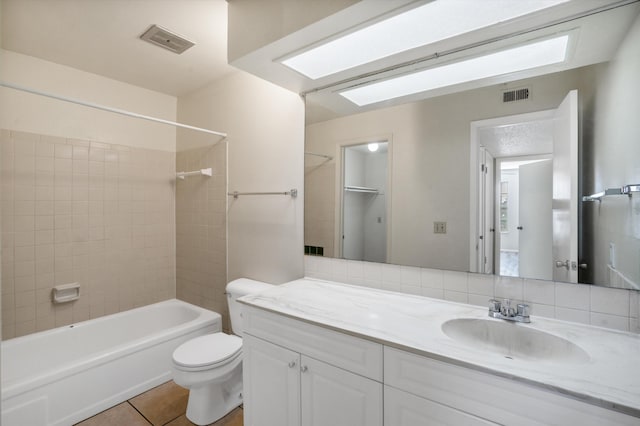 bathroom featuring visible vents, toilet, vanity, tile patterned flooring, and shower / bathtub combination