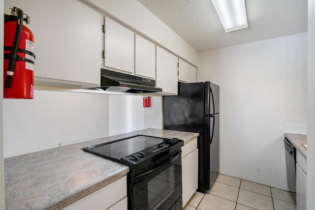 kitchen with black appliances, under cabinet range hood, a textured ceiling, white cabinetry, and light tile patterned flooring