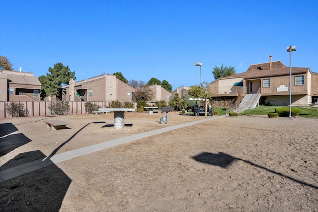 view of yard featuring stairway, fence, and a residential view