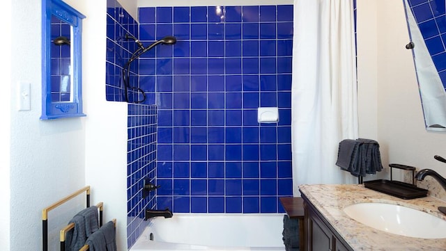 bathroom featuring vanity and shower / bathtub combination with curtain