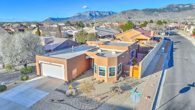 drone / aerial view featuring a residential view and a mountain view