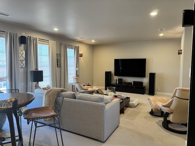 carpeted living area with recessed lighting, visible vents, and baseboards