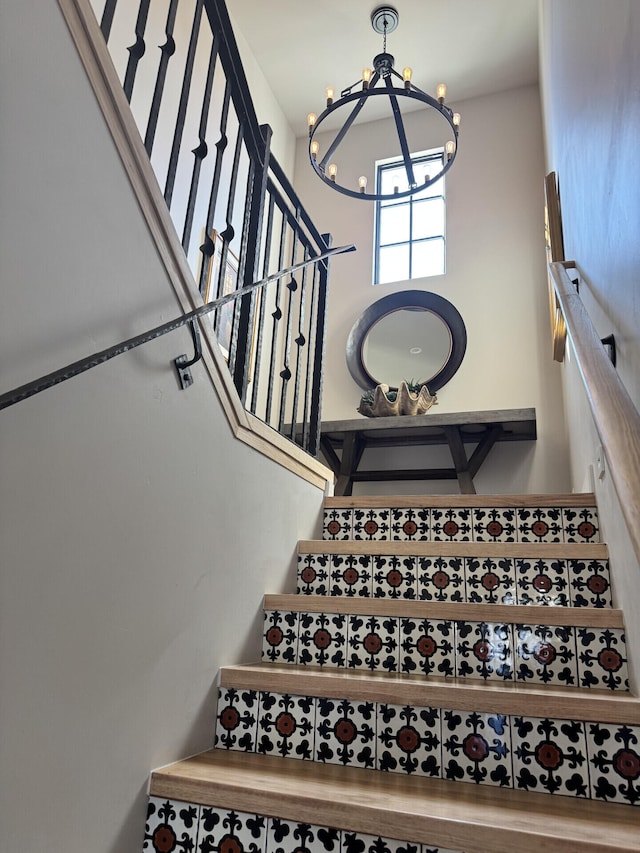 staircase featuring an inviting chandelier