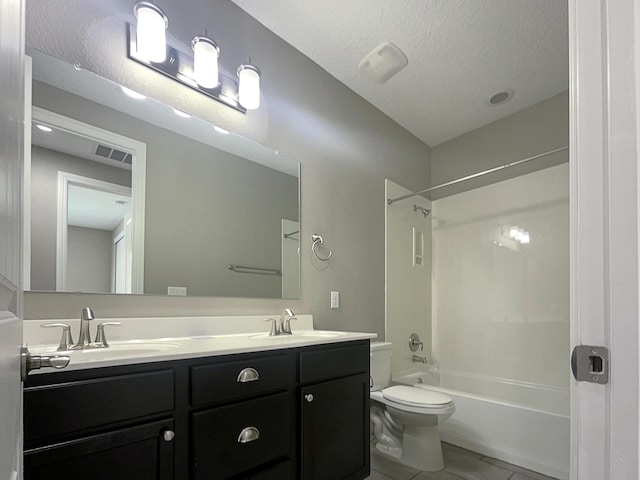 full bath with a textured ceiling, toilet, bathtub / shower combination, and a sink