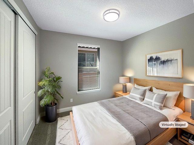 carpeted bedroom featuring a closet, baseboards, and a textured ceiling