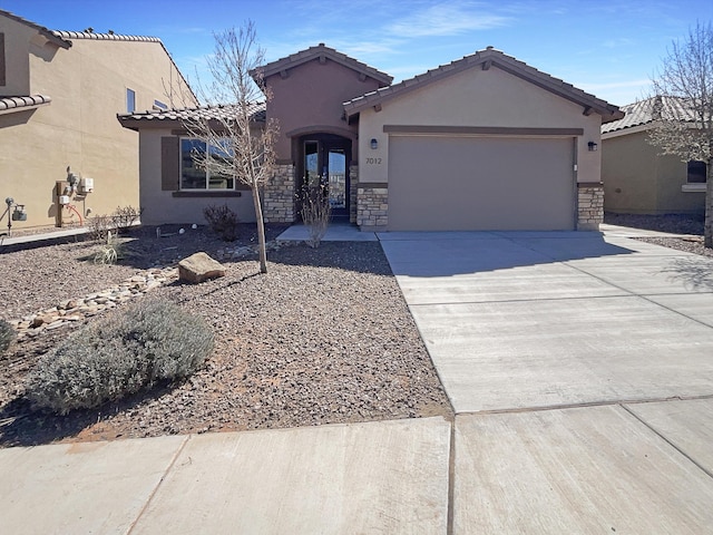 single story home with stucco siding, concrete driveway, french doors, a garage, and stone siding