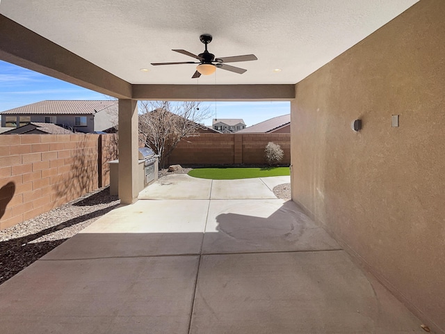 view of patio / terrace with area for grilling, a ceiling fan, and a fenced backyard