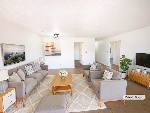 living room featuring tile patterned floors and a textured ceiling