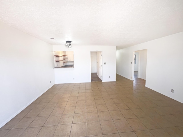 spare room with a textured ceiling