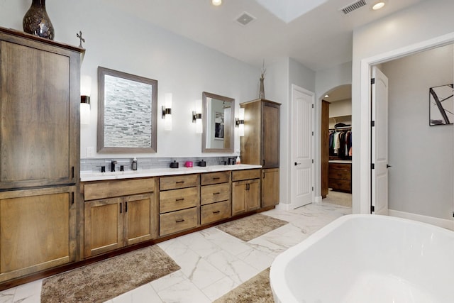 full bath featuring a soaking tub, visible vents, marble finish floor, and recessed lighting