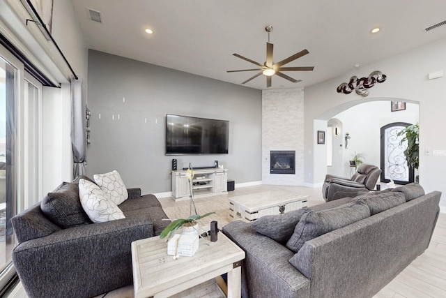 living room with visible vents, recessed lighting, a fireplace, and a ceiling fan