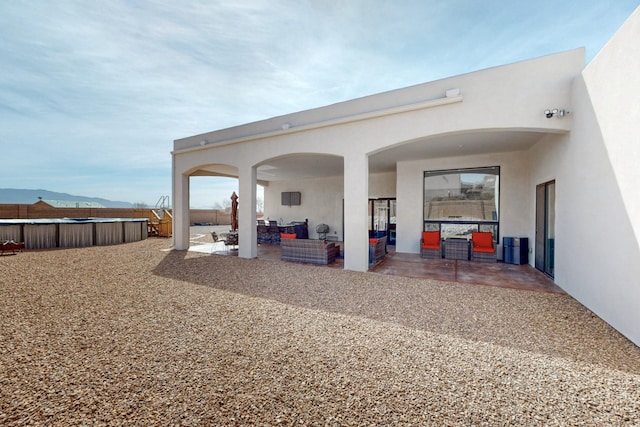 view of patio featuring an outdoor pool, a mountain view, and an outdoor hangout area