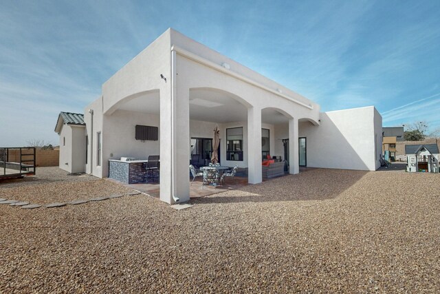 5721 Rio Animas Rd NE, Rio Rancho, NM 87144 - rear view of property with area for grilling, a patio, and stucco siding