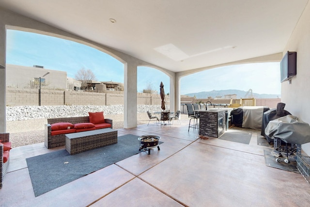 5721 Rio Animas Rd NE, Rio Rancho, NM 87144 - fenced backyard with outdoor lounge area, outdoor dining area, a patio area, a mountain view, and area for grilling