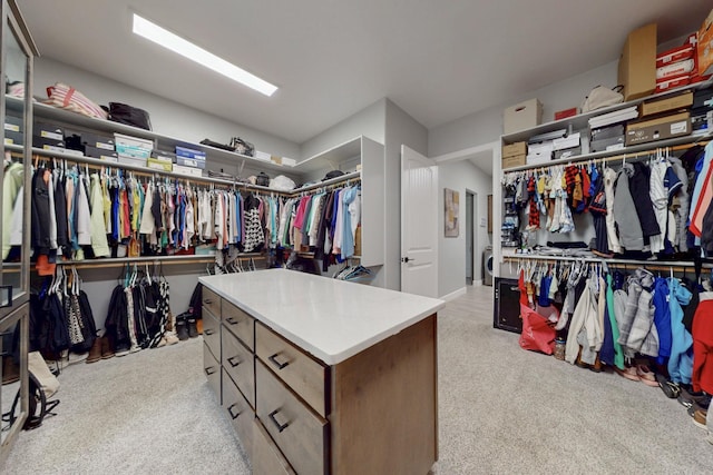 walk in closet with light carpet