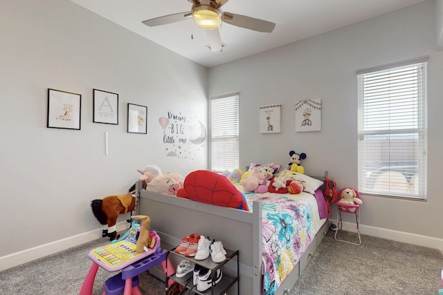 carpeted bedroom with baseboards and ceiling fan