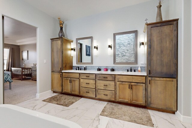 5721 Rio Animas Rd NE, Rio Rancho, NM 87144 - bathroom featuring marble look tile flooring, double vanity, backsplash, and a bath