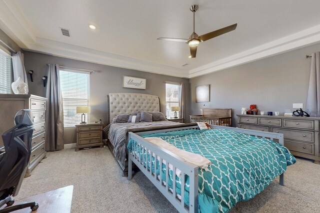 5721 Rio Animas Rd NE, Rio Rancho, NM 87144 - bedroom featuring a tray ceiling, light carpet, and multiple windows