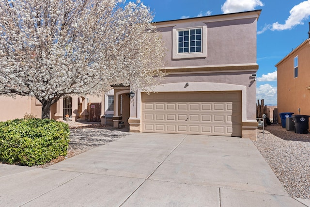 view of front facade with stucco siding, concrete driveway, and a garage