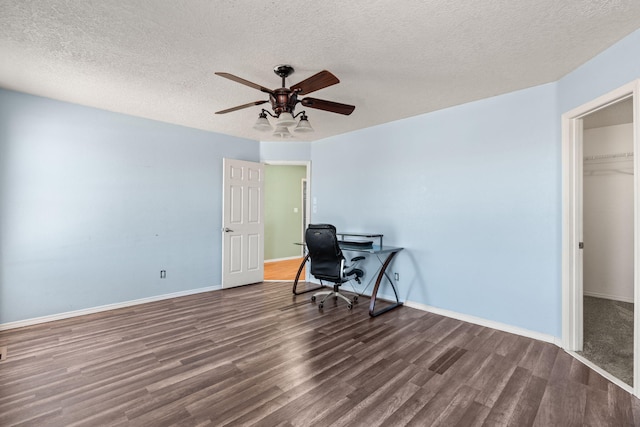 office space with a textured ceiling, baseboards, ceiling fan, and wood finished floors