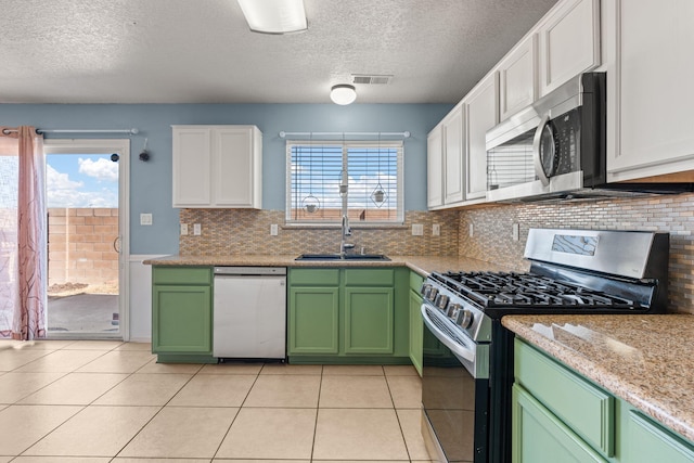 kitchen featuring visible vents, a sink, white cabinetry, appliances with stainless steel finishes, and green cabinetry