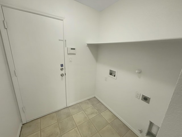 laundry area with gas dryer hookup, light tile patterned flooring, hookup for an electric dryer, hookup for a washing machine, and laundry area