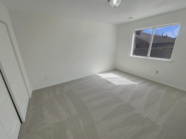 interior space featuring carpet flooring, visible vents, and baseboards