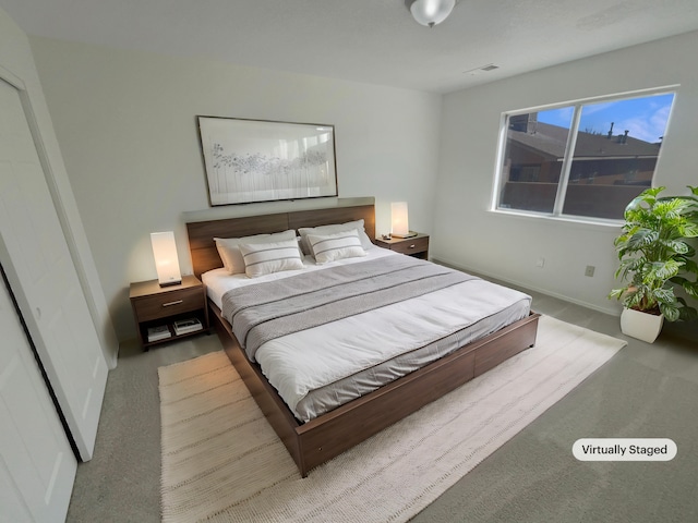 carpeted bedroom with visible vents and baseboards