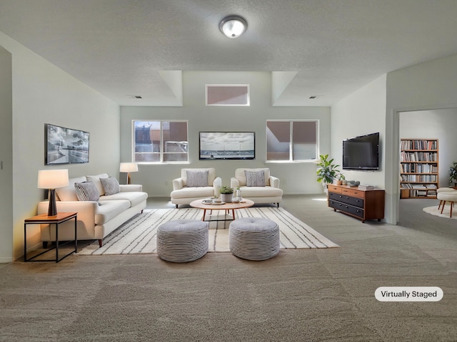 living area with visible vents, carpet floors, and a textured ceiling