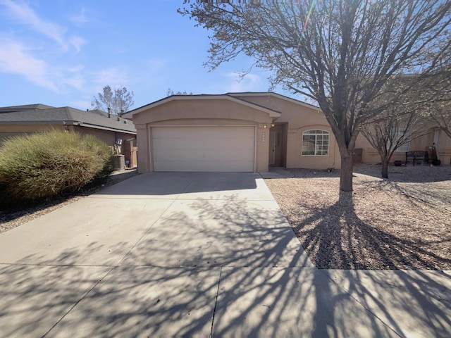 view of front of house with stucco siding, a garage, and concrete driveway