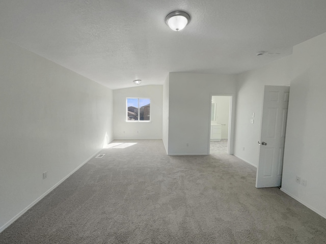 carpeted empty room with visible vents, baseboards, and a textured ceiling