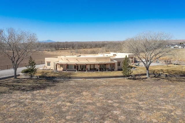 back of property featuring stucco siding and a mountain view