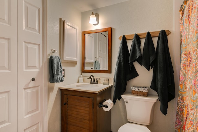 bathroom featuring toilet and vanity